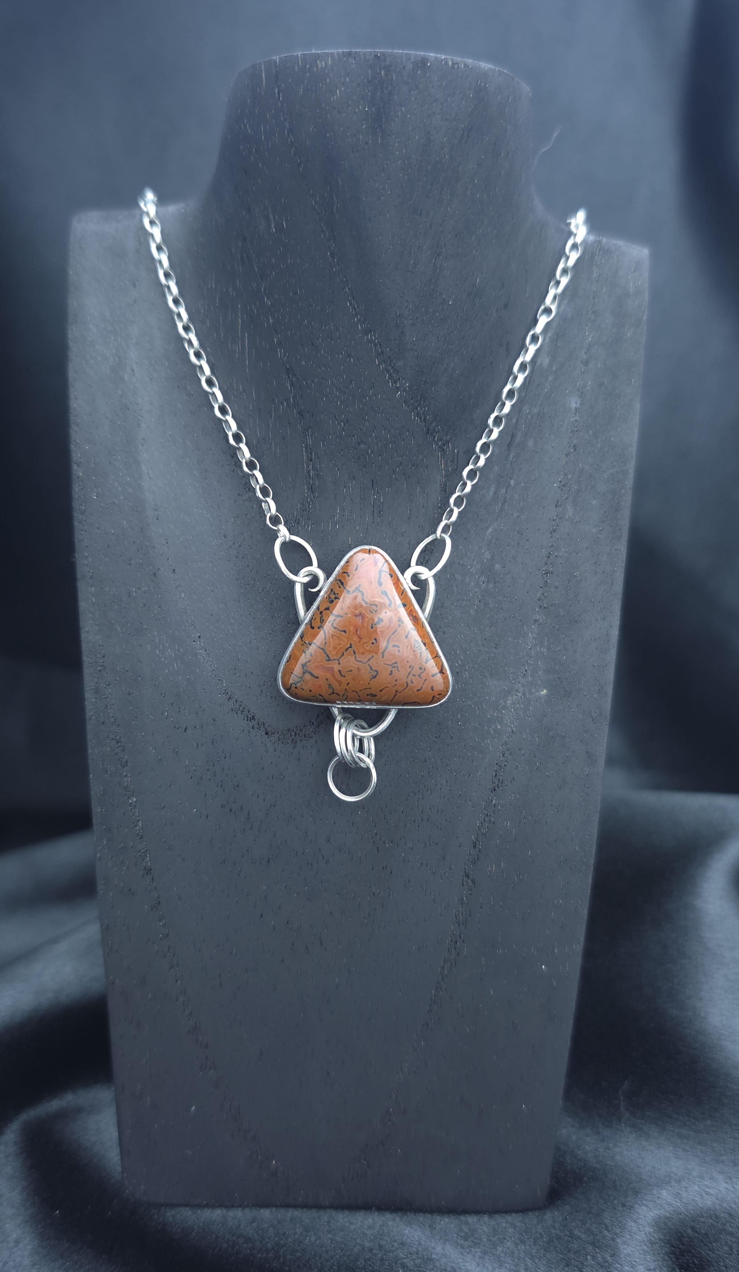 Handcrafted pendant with agatized dinosaur bone set in sterling silver