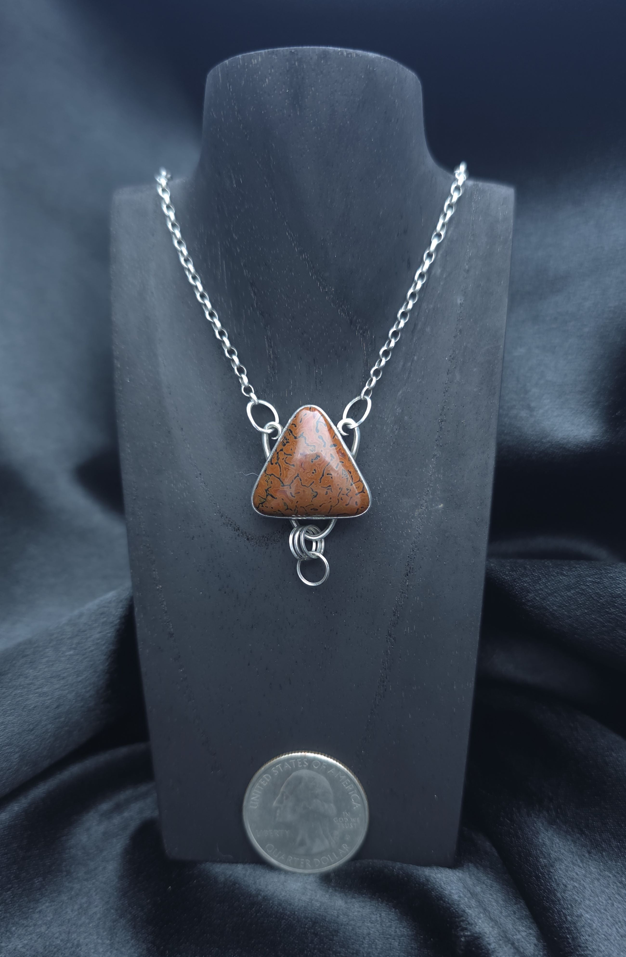 Handcrafted pendant with agatized dinosaur bone set in sterling silver