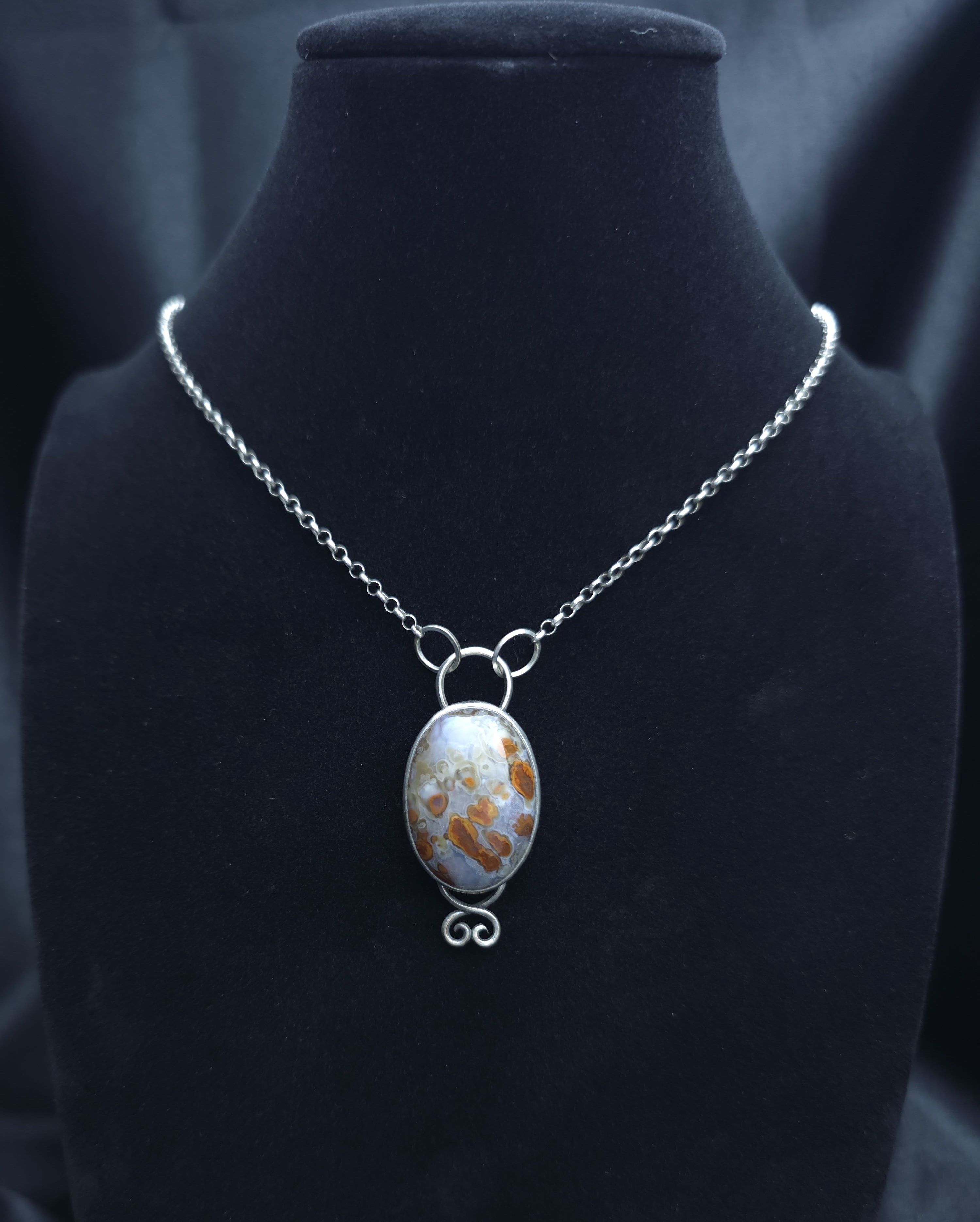 Pendant of red plume agate set in sterling silver