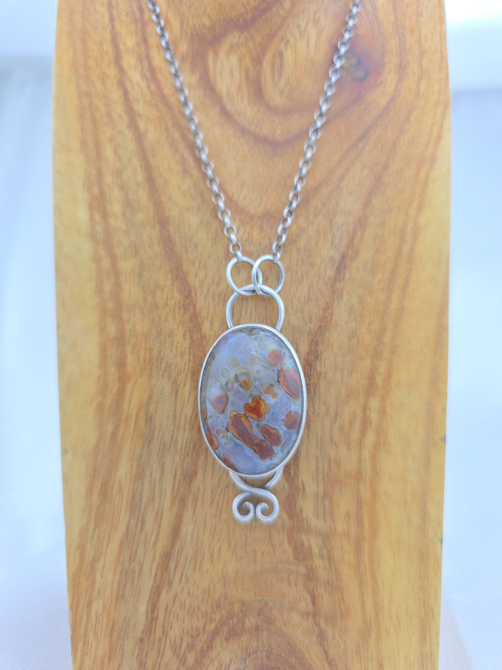 Pendant of red plume agate set in sterling silver