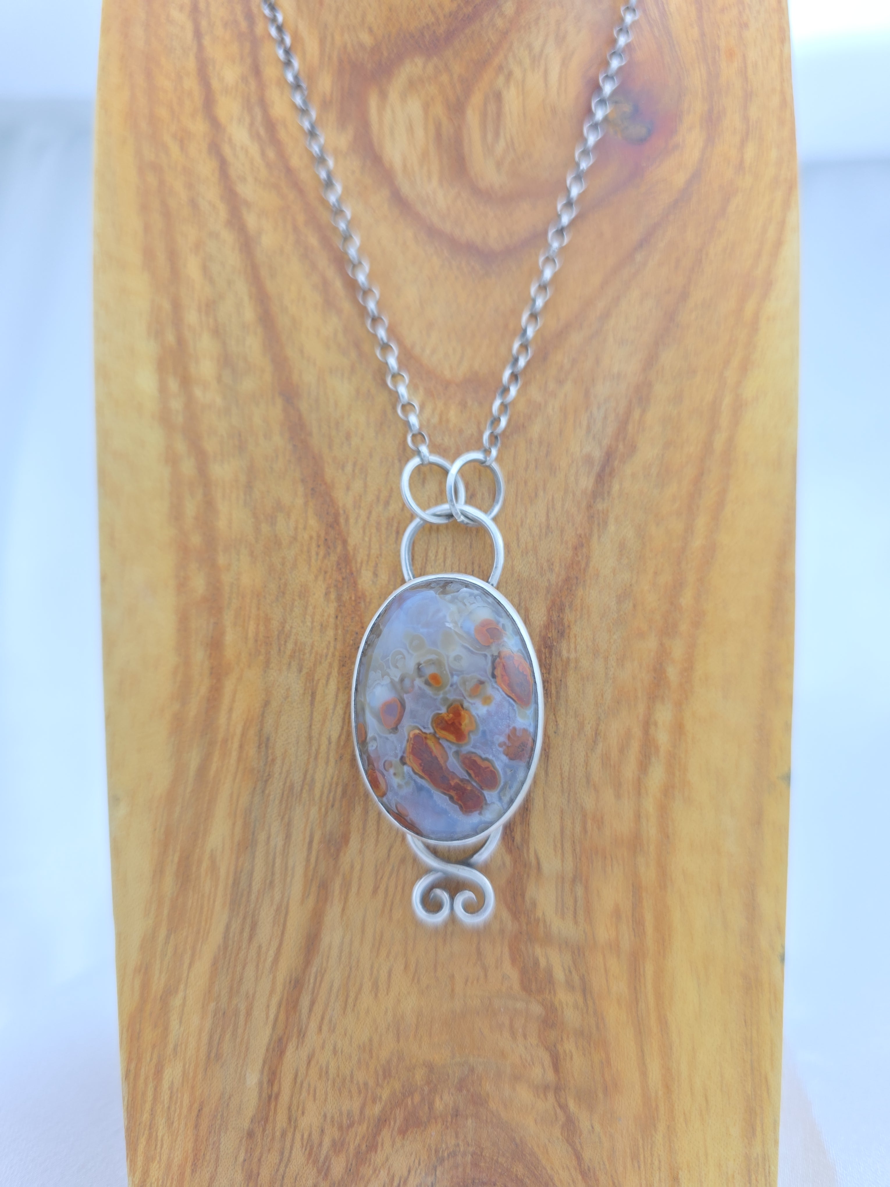 Pendant of red plume agate set in sterling silver