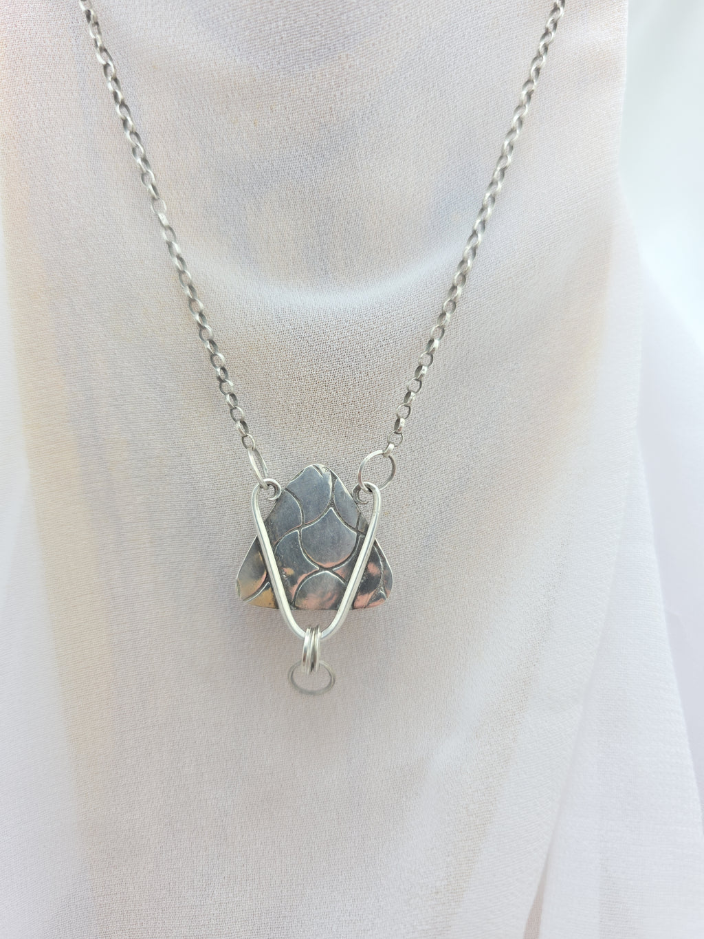 Handcrafted pendant with agatized dinosaur bone set in sterling silver