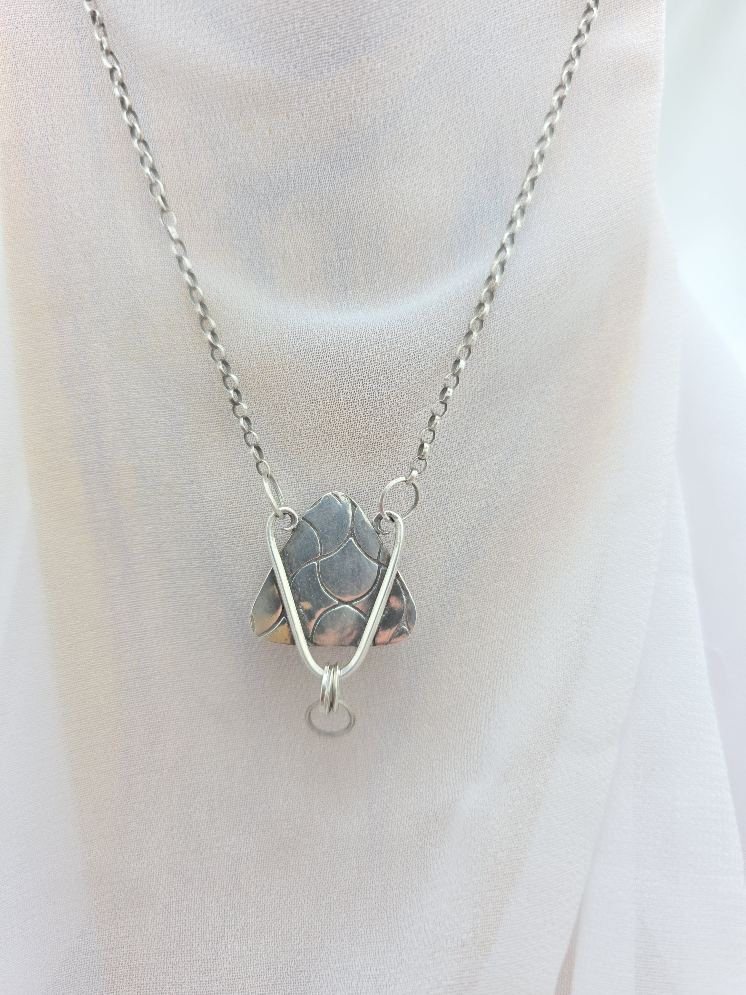 Handcrafted pendant with agatized dinosaur bone set in sterling silver
