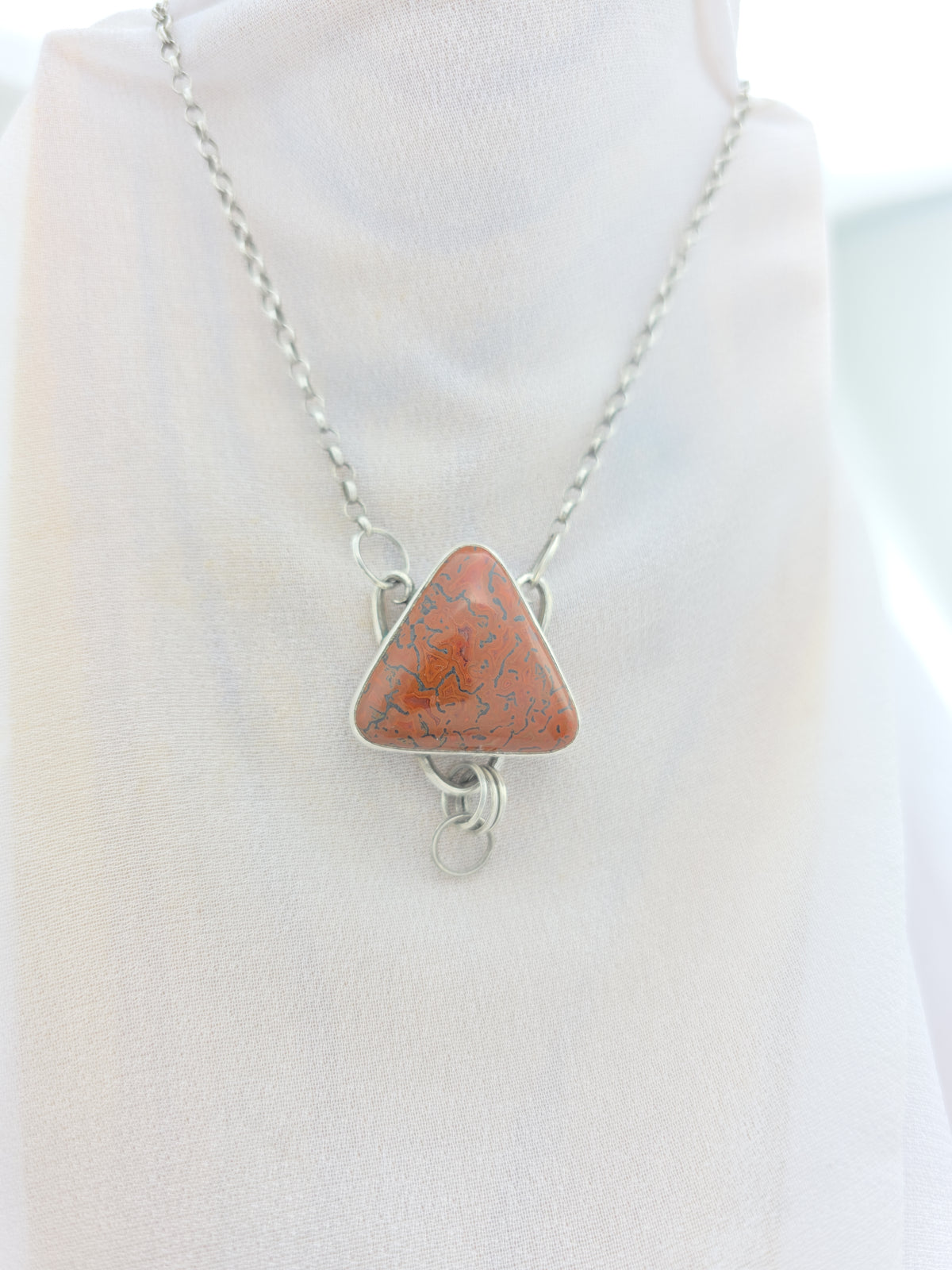 Handcrafted pendant with agatized dinosaur bone set in sterling silver