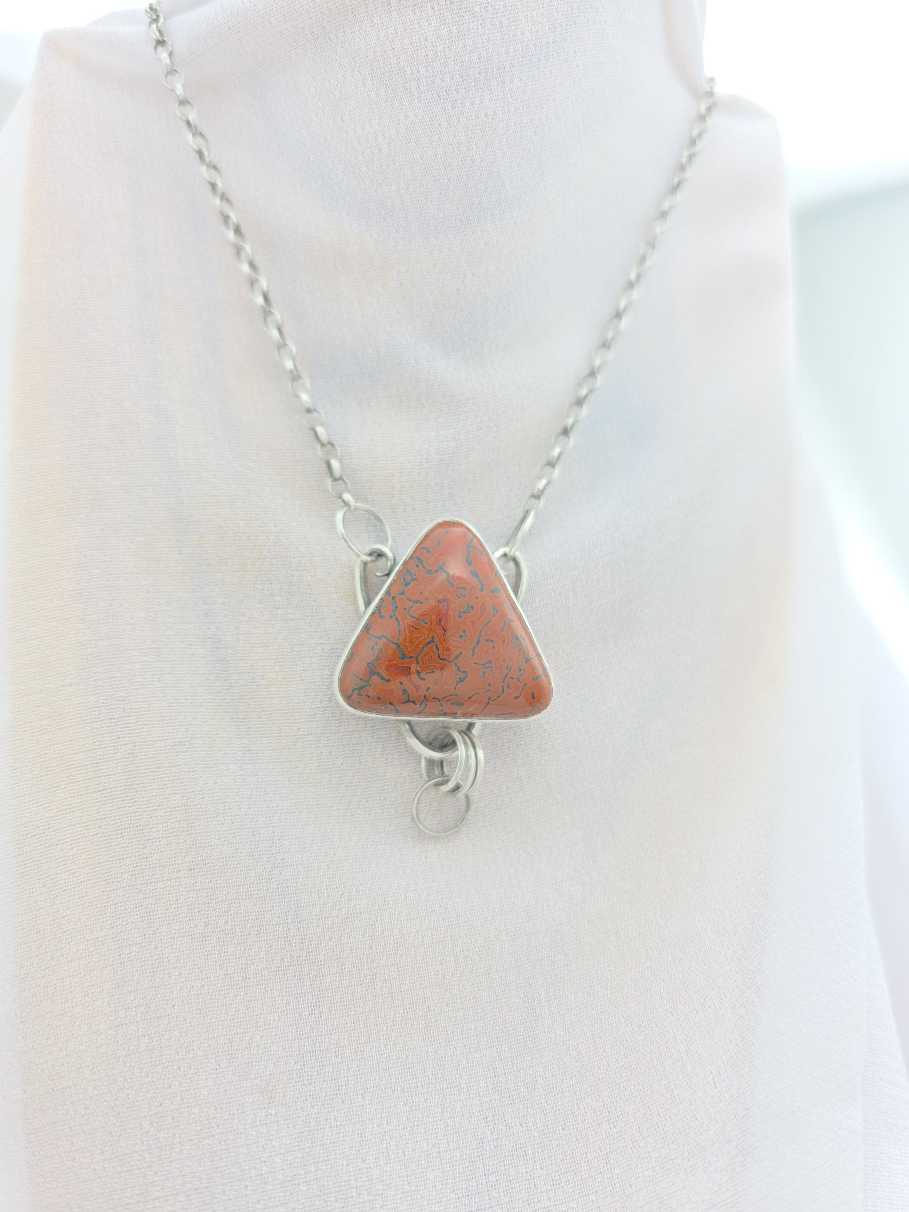 Handcrafted pendant with agatized dinosaur bone set in sterling silver
