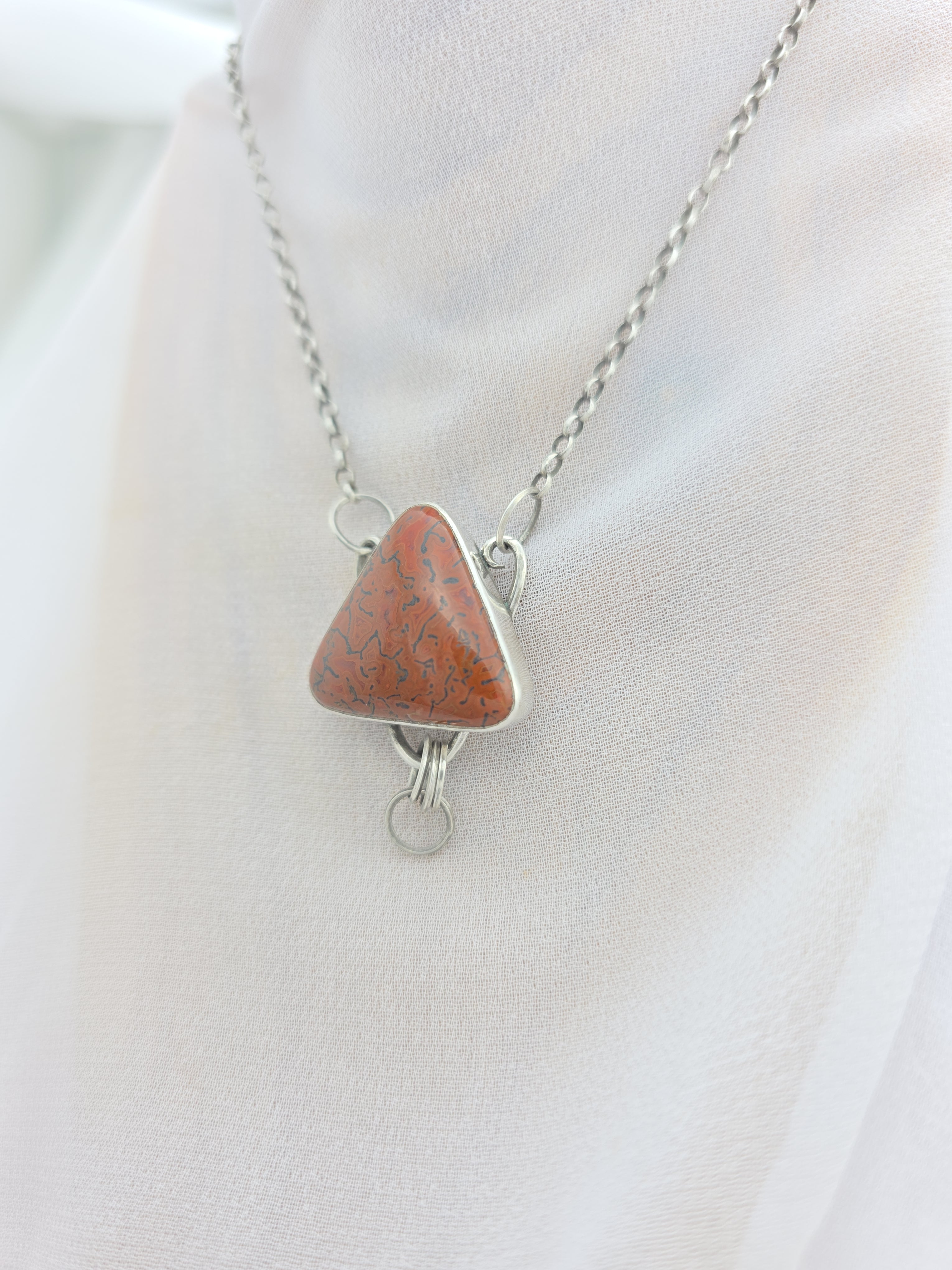 Handcrafted pendant with agatized dinosaur bone set in sterling silver