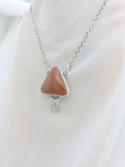 Handcrafted pendant with agatized dinosaur bone set in sterling silver